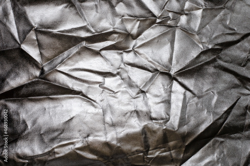 Silver foil texture  shiny and folded. Abstract silver background.