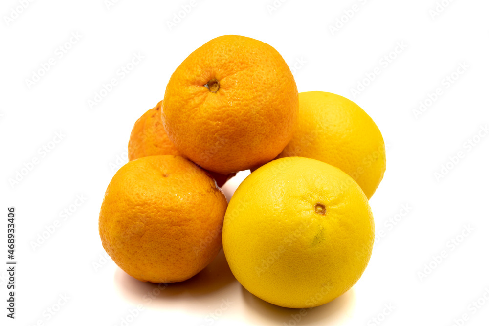 Ripe tangerines and oranges on a white background. Close-up Ripe tangerines and oranges on a white background. Close-up