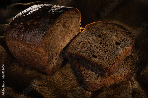 Fresh cutted bread baked homemade artisan sourdough rye on table close-up. Fresh bread on the kitchen table. Traditional bakery concept. Rustic style