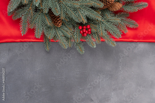 Christmas tree branches on gray gray background as a border or template for Christmas card