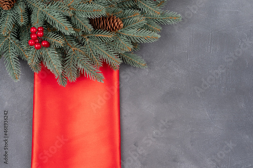 Christmas border branches of fir tree with decoration and red winter berries. Background with copy space