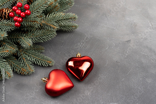 Green Christmas wreath with decorations of two heart shape bubble on a gray background