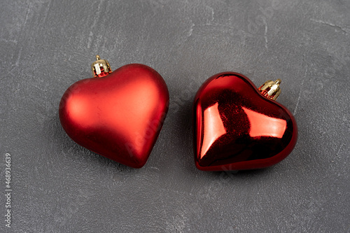 Two red hearts on gray concrete background, Christmas decoration