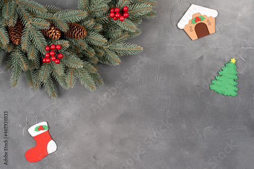 Christmas composition. Holiday wreath frame on gray background. Flat lay, top view holiday decoration concept