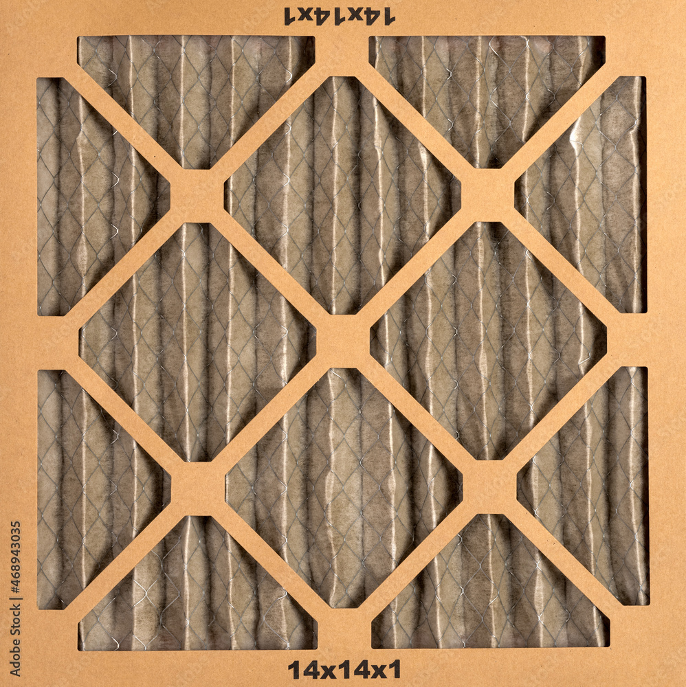 14 x 14 x 1 size dirty home air filter close up that needs to be replaced. 14 x 14 x 1 size dirty home air filter close up that needs to be replaced.