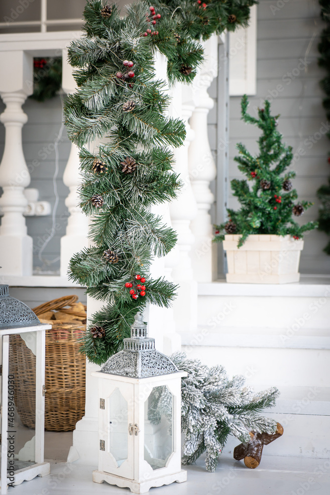 Christmas morning. porch a small house with a decorated door with a Christmas wreath. Winter fairy tale.