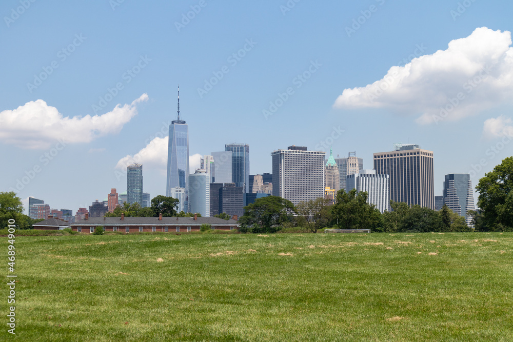 Lower Manhattan Skyline seen from a Green Grass Field on Governors Island in New York City during the Summer