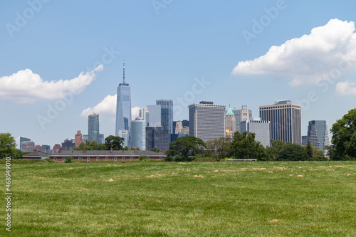 Lower Manhattan Skyline seen from a Green Grass Field on Governors Island in New York City during the Summer