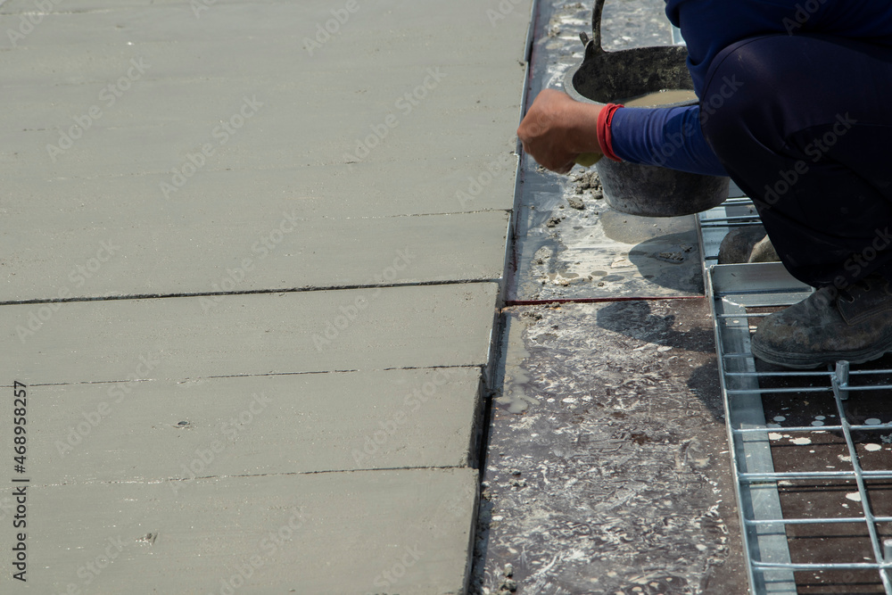 cement surface adjusting with hand of worker and waiting for cure by sunligth in out door in hands hold spong cement surface adjusting with hand of worker and waiting for cure by sunligth in out door in hands hold spong
