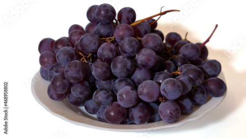 Grapes on a white plate on a white background