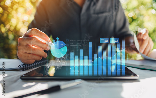 Businessman work with ai for economy analysis financial result by digital augmented reality graph. Concept for entrepreneur leader of invest in business and digital marketing technology of the future. photo