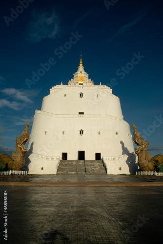 The large white pagoda at PhrabMahathat Kodsapanyo Sripanom The chedi has a mountain-like shape, 56 meters high.Located in  Nakhon Phanom province in Northeast of Thailand. photo