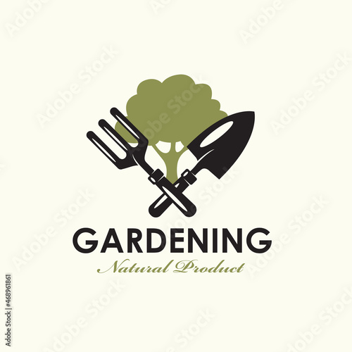 gardening emblem with trowel spade, garden fork and green tree