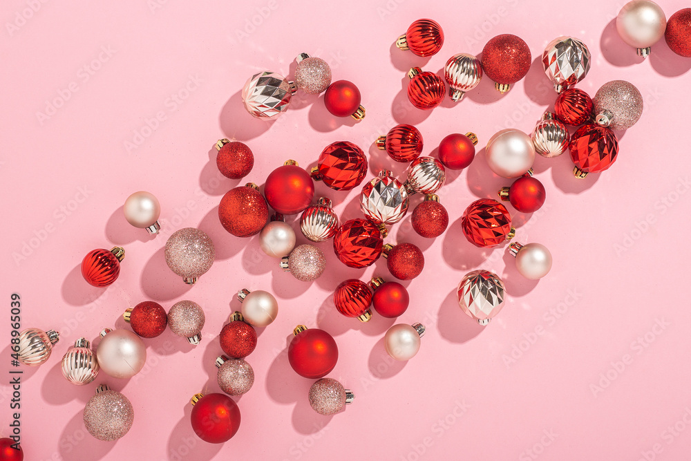 Pink and red decorative balls on a pink background. Top view, flat lay. Pink and red decorative balls on a pink background. Top view, flat lay.