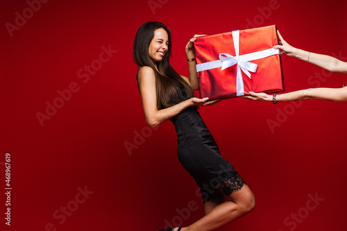 Laughing woman in black recieving present. photo