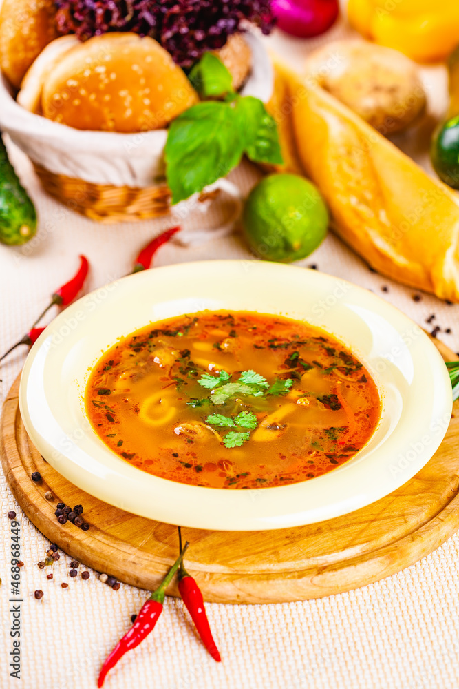 Vegetable soup with herbs and spices in white plate