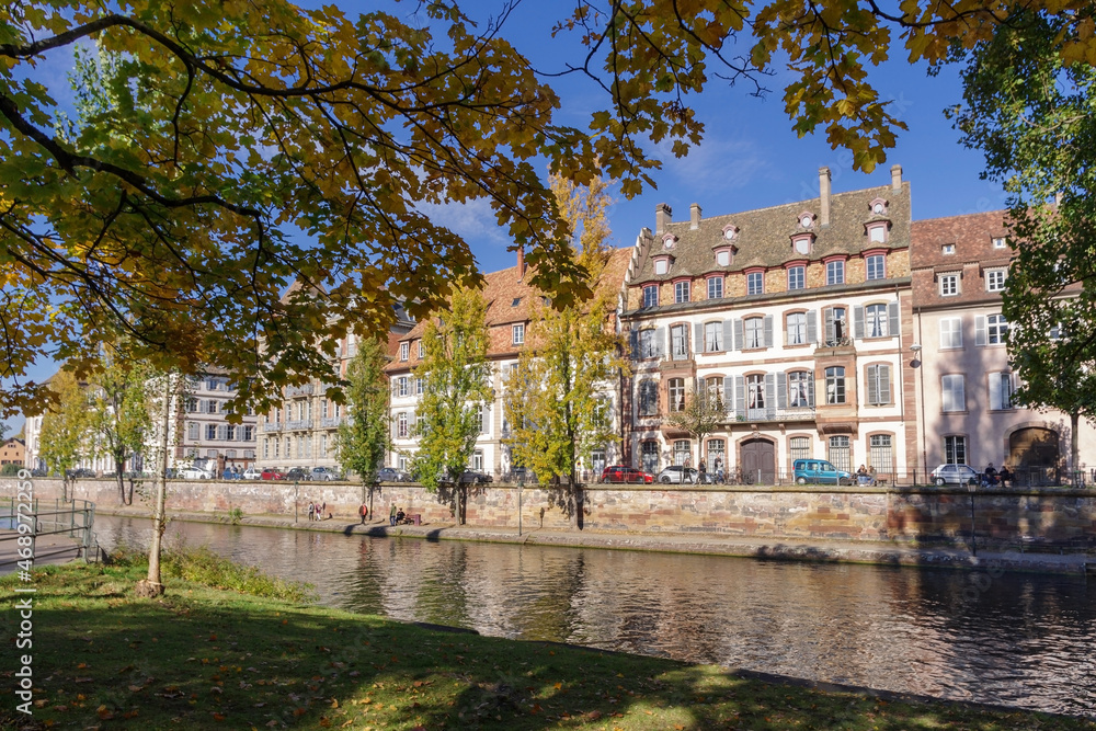 France, Strasbourg, Ill River canal with promenade and row of town houses