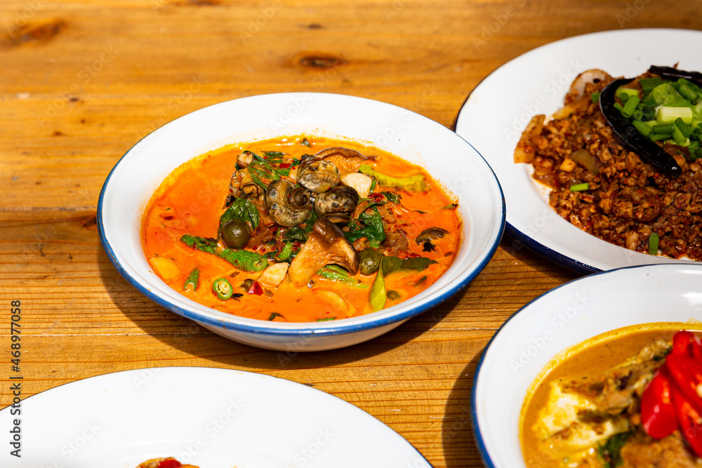 River snail red curry in red curry coconut milk soup in bowl. Thai Food River snail red curry in red curry coconut milk soup in bowl. Thai Food
