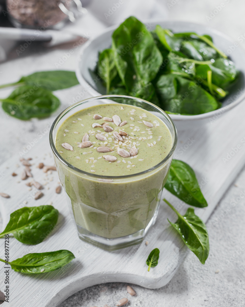 Glass of homemade healthy green smoothie with fresh baby spinach Glass of homemade healthy green smoothie with fresh baby spinach