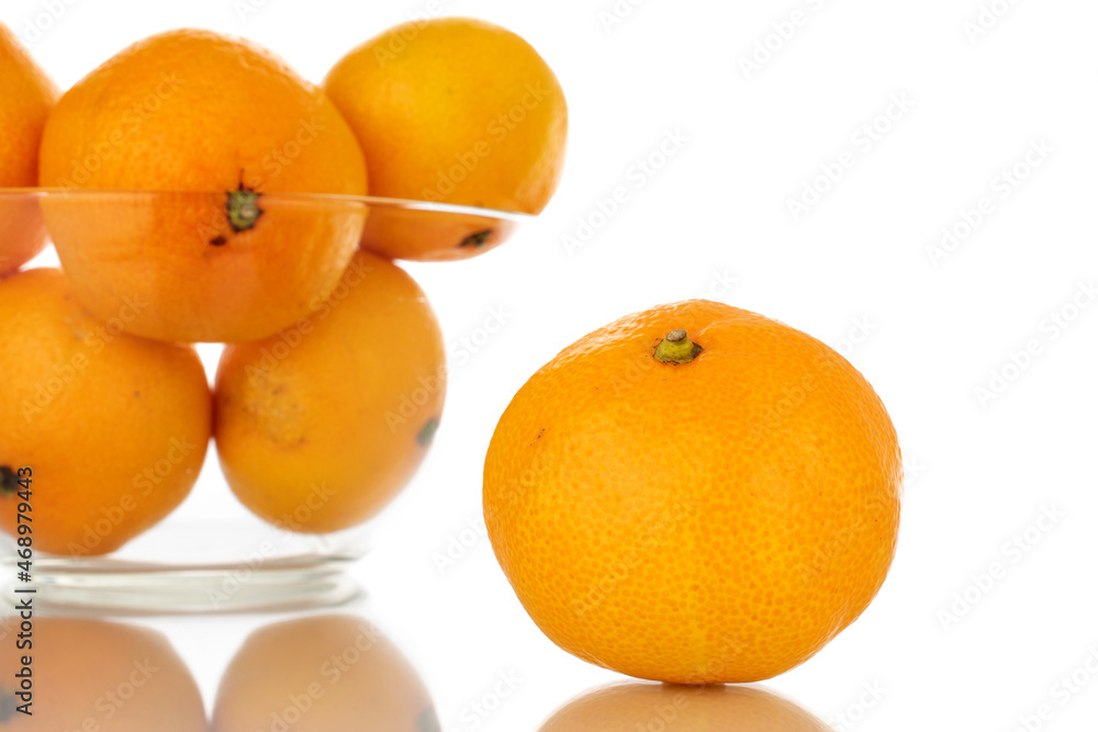 Several ripe organic tangerines in a glass dish, close-up, isolated on white. Several ripe organic tangerines in a glass dish, close-up, isolated on white.