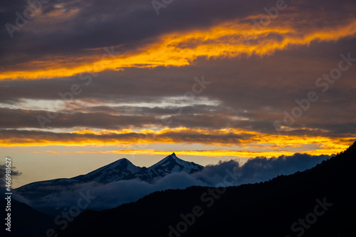 Sunset behind a snowy mountain