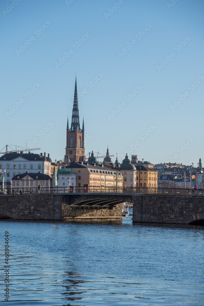 The bridge Stadshusbron  and the church Riddarholmskyrkan  on the island Riddarholmen a colorful autumn day in Stockholm
