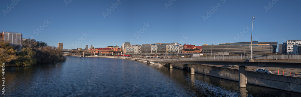 The channel Klara sjö with train station, the busy road Klara Strandsleden, apartments and office buildings a colorful autumn day in Stockholm