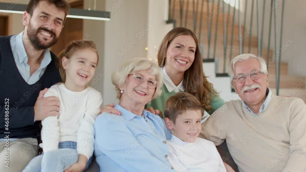 Multi generation family sitting together on the sofa at home Multi generation family sitting together on the sofa at home