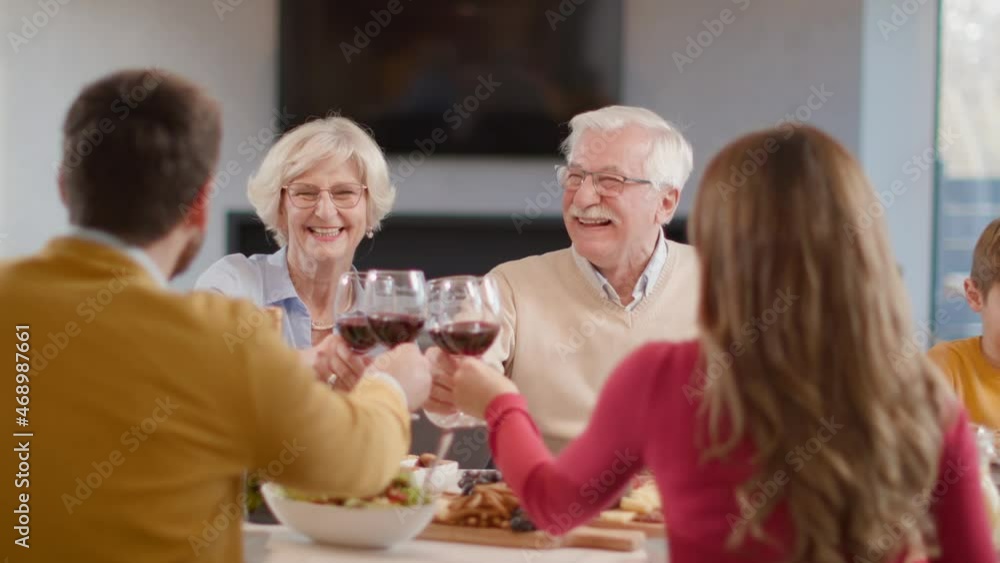 Happy family having a dinner with red wine at home Happy family having a dinner with red wine at home