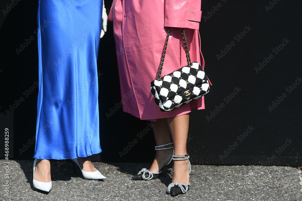 Milan, Italy - September 24, 2021: Street style outfit, two fashionable  women wearingpink oversized coat, checkered black white Chanel bag, heels  and Stock Photo - Alamy
