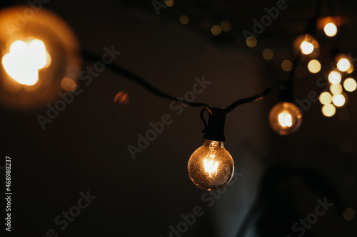 photo of a garland of light bulbs on a dark background. selective focus. christmas and new year concept 