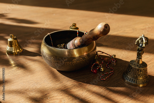 Tibetan singing bowls, bells, for meditation and relaxation on wooden floor. Hamdmade percussion music instruments. Sound massage and healng.