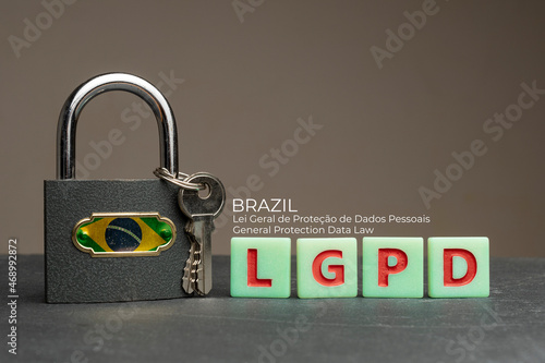 LGPD (brazilian data protection law) concept: lock with brazil flag on a table with some plastic tiles with the acronym of the Brazilian data protection law (Lei Geral de Proteção de Dados Pessoais). photo