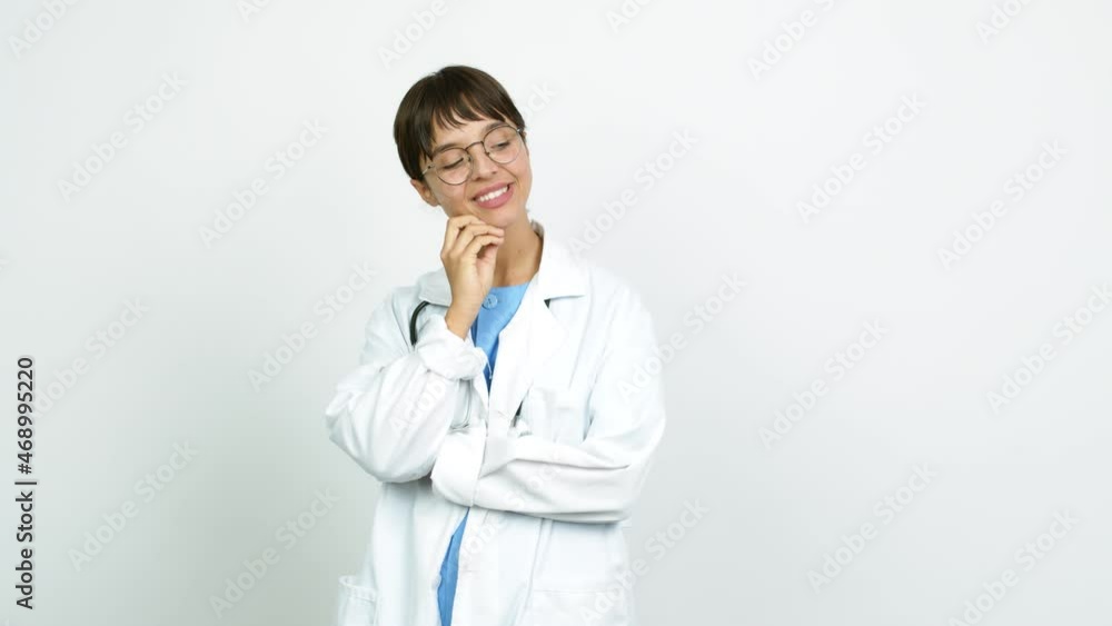 Young woman with nurse uniform standing and looking to the side over isolated background Young woman with nurse uniform standing and looking to the side over isolated background