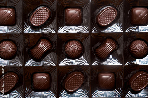 Dark bitter chocolate candies in a box.