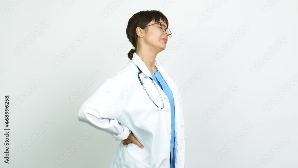 Young woman with nurse uniform suffering from pain in shoulder for having made an effort over isolated background Young woman with nurse uniform suffering from pain in shoulder for having made an effort over isolated background