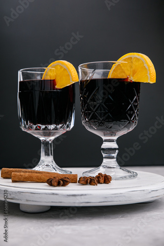 Mulled wine on a stand with oranges and spices