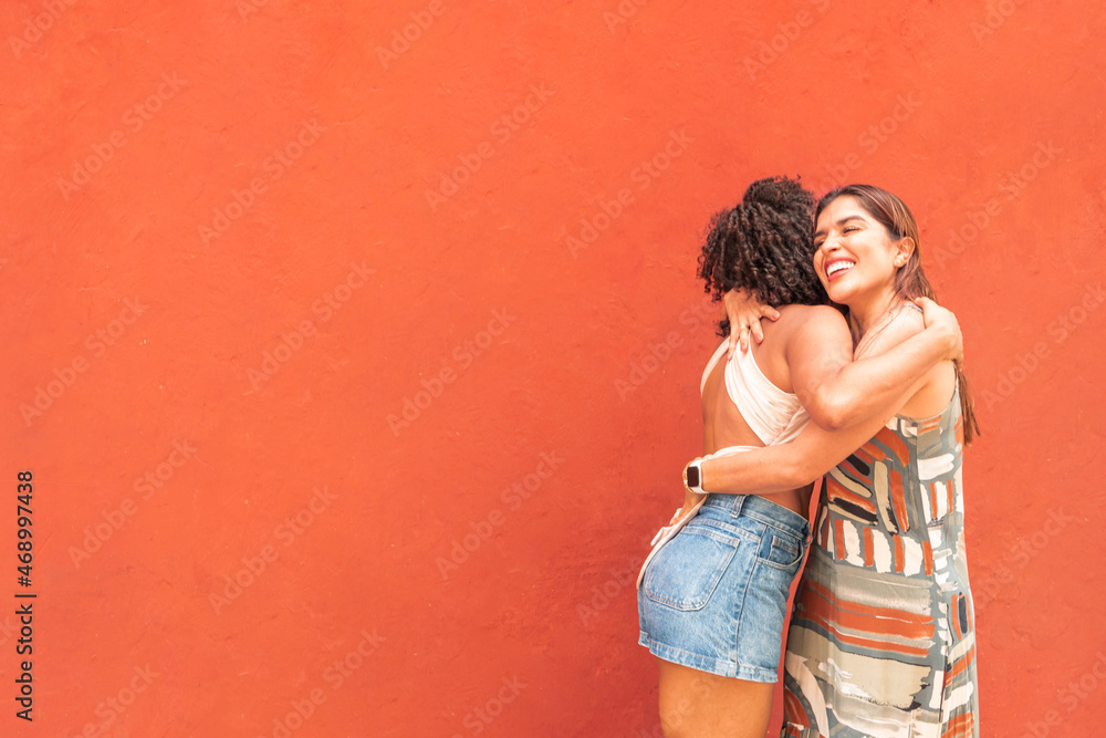 Best friends showing love by hugging each other after meeting on the street. Best friends showing love by hugging each other after meeting on the street.