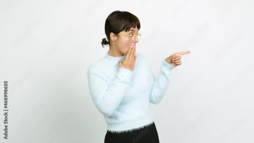 Young woman pointing to the side and presenting a product while smiling over isolated background Young woman pointing to the side and presenting a product while smiling over isolated background