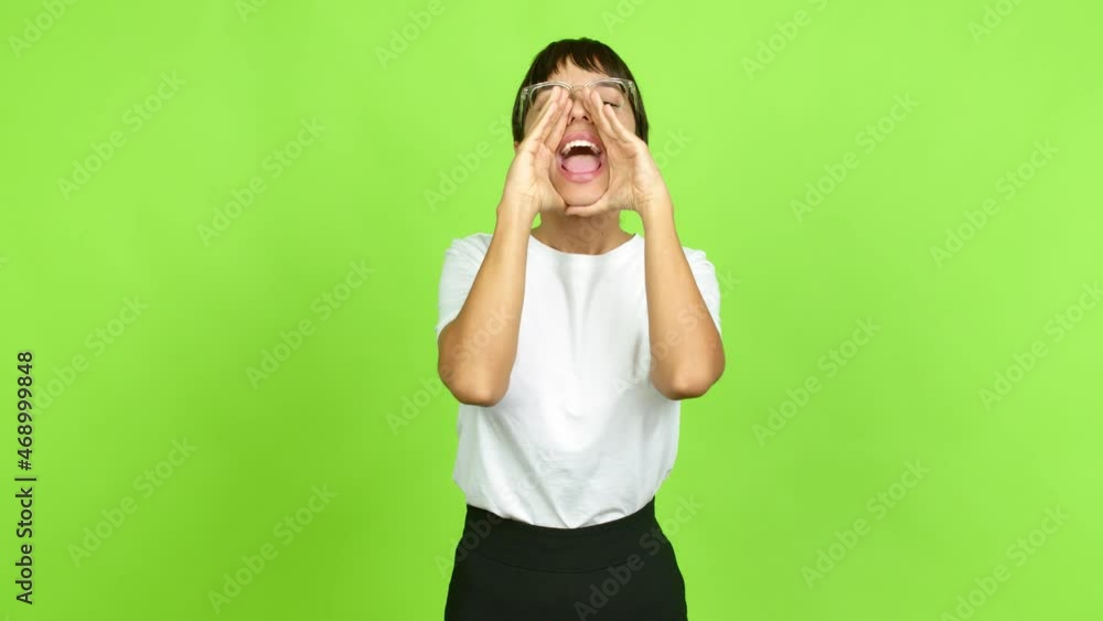 Young woman shouting and announcing something over isolated background. Green screen chroma key Young woman shouting and announcing something over isolated background. Green screen chroma key