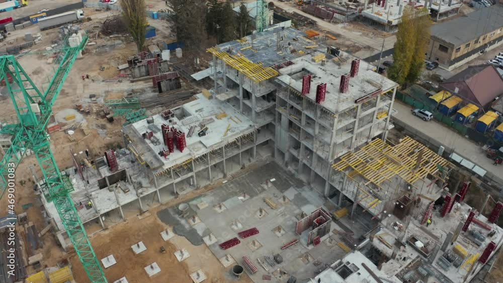 High crane works on building site with a house. Urban Construction Site, Aerial View. Construction area, building area, site area from above. New appartments getting built High crane works on building site with a house. Urban Construction Site, Aerial View. Construction area, building area, site area from above. New appartments getting built