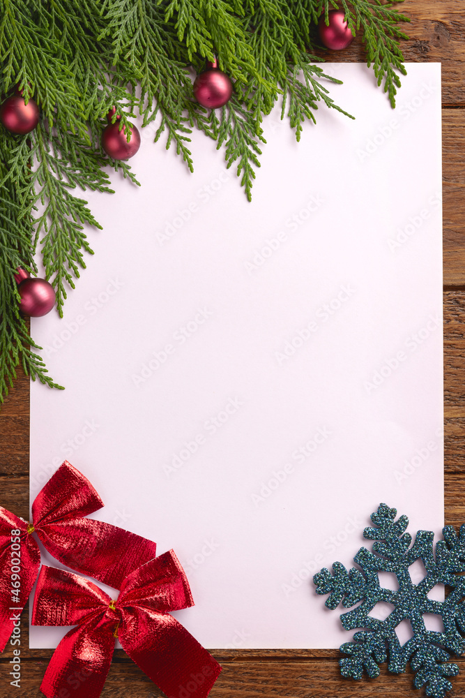 Obraz premium Holiday Christmas card with fir tree and festive decorations balls, stars on wood background. Christmas template for banner, ticket, leaflet, card, invitation, poster