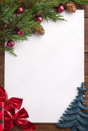 Holiday Christmas card with fir tree and festive decorations balls, stars on wood background. Christmas template for banner, ticket, leaflet, card, invitation, poster