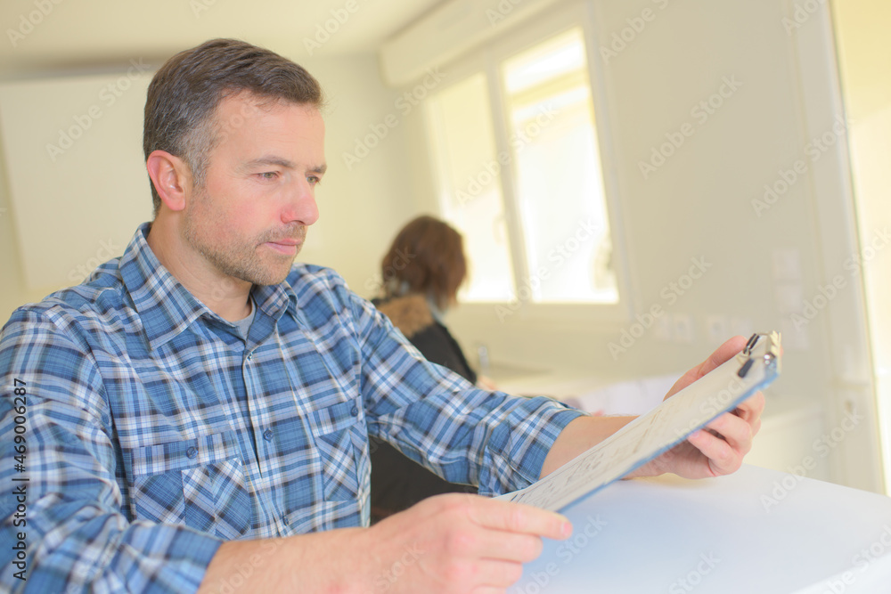 Fototapeta premium a plumber with clipboard indoors