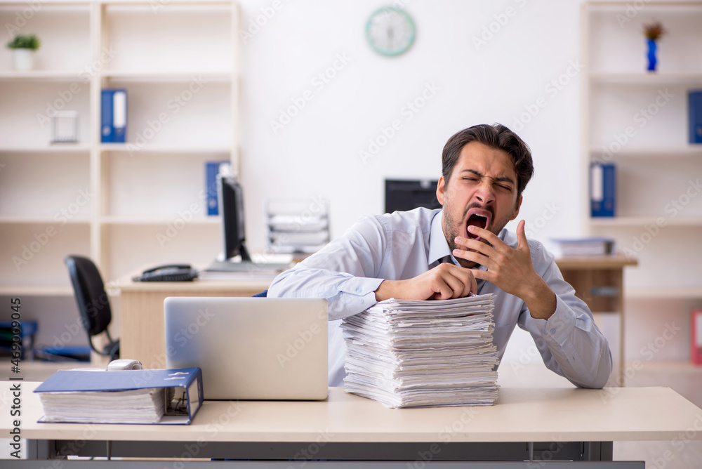 Young male employee working in the office Young male employee working in the office