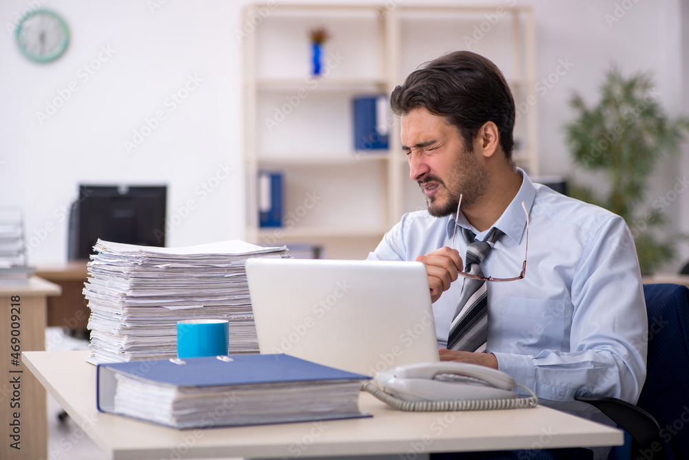Young male employee working in the office Young male employee working in the office