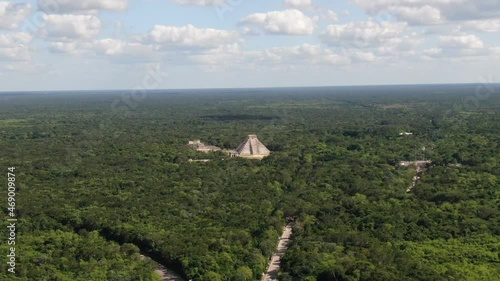 4K Aerial View of Chichen Itza, Temples Complex of Ancient hidden Mayan City in Mexican Rainforest, Drone Shot. Famous Kukulkan Pyramid in the middle of nature. Yucatan, Mexico. Pyramid El Castillo. photo