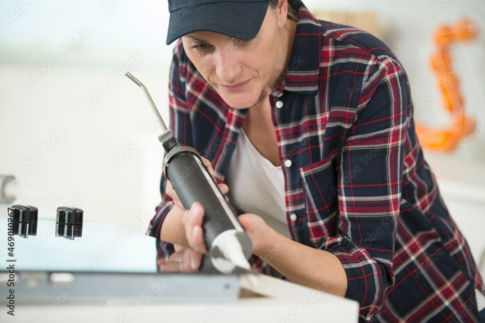 Fototapeta premium a woman is repairing kitchen