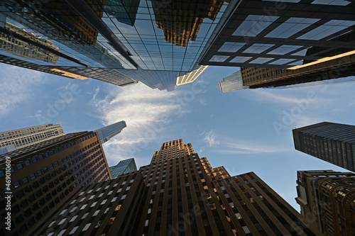 Upward view of skyscrapers in New York City  New York against early morning sky with high altitude clouds.