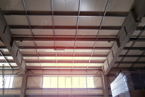 Metal structures on the ceiling of industrial building, warehouse, workshop. complex vaulted ceiling with crossbars beams ceilings inside factory building for industrial background.